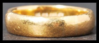 A hallmarked 22ct gold band ring of usual form weighing 5 g and measuring size
