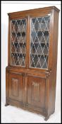 A mid century Regency revival solid oak library bookcase cabinet. Twin astragal glazed display