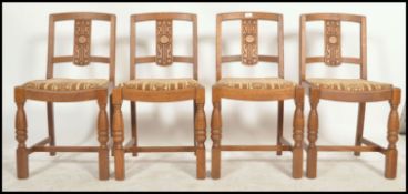 A set of 4 1930's Art Deco oak dining chairs being