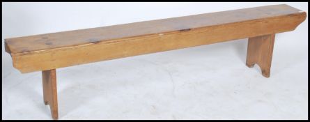 A 19th century pine refectory pig bench. Raised on