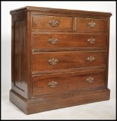 An Edwardian mahogany chest of drawers being raised on a plinth base with 2 short over 3 deep