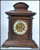 A vintage 20th century HAC wooden cased mantle clock having a columned hood. The enamel face