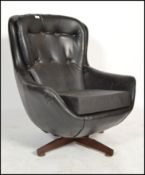 A vintage Scandinavian Parker Knoll black faux leather swivel button back pod armchair with five