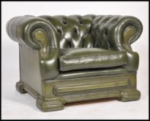 A 20th century Chesterfield green leather button back club armchair, low back with scroll arms.