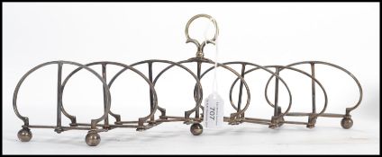 A 19th century silver plate expanding metamorphic toast rack. Raised on bun feet with a scissor