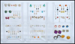 A large collection of costume jewellery earrings to include yellow and white metal examples being