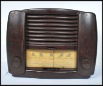 A vintage mid 20th century Bakelite GEC model BC4850 - L valve radio, dials and display to front.