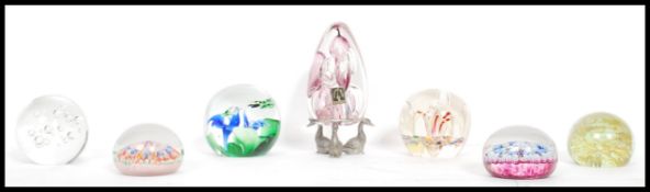 A collection of paperweights to include Perthshire Millefiori cane weight, another millefiori,