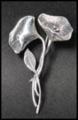 A 925 silver Art Nouveau style figural brooch in the form of  a flower spray  having a roller clip