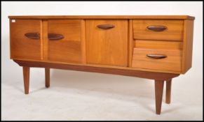 A vintage mid century teak wood sideboard in the Danish manner having 2 angular drawers to the