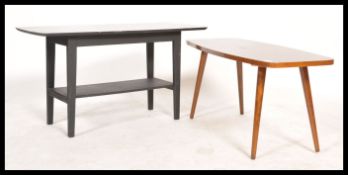 A vintage mid century ebonised coffee table having black marble effect top with magazine rack to the