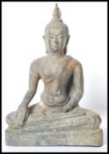 A 19th century Oriental Chinese bronze Buddha modelled in the lotus position raised on a pedestal