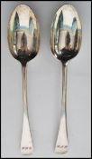 A pair of silver hallmarked table / serving spoons by Josiah Williams & Co (George Maudsley