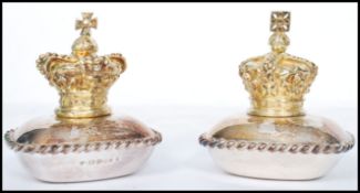A pair of silver hallmarked lidded table salts, the top surmounted with a gilt crown under which