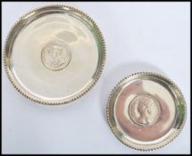 two silver white metal peanut dishes / coasters, each with a bead work border and a centrally