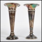 A pair of silver hallmarked candlestick vases by Edward Barnard & Sons Ltd, Birmingham 1944.