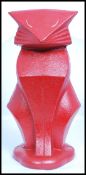 A vintage Art Deco style cast metal door stop in the form of a stylised Art Deco seated cat,