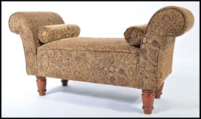 A contemporary good quality double ended window seat being raised on turned legs with a good