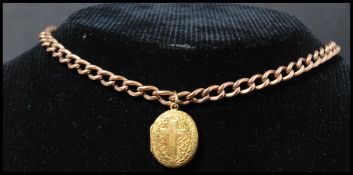 A hallmarked 9ct gold Albert chain having a claw clasp with an 18ct gold tested locket pendant. Each