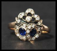 A 9ct gold sapphire and diamond sweetheart  ring having two sapphire set hearts surrounded by a halo