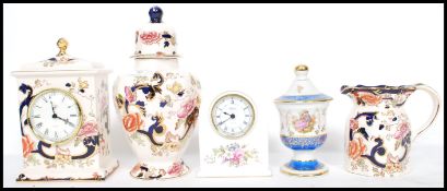 A Mason's Mandalay pattern mantel clock, ginger jar and jug being stamped to the base together