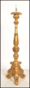 A large ornate gilt standard lamp raised on moulded tripod legs with gadrooning and acanthus leaf