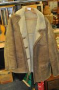 A vintage 20th century hip length gents sheepskin coat approximately size 46, slightly torn to one