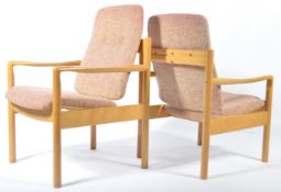 A pair of retro 20th century low Ercol staff industrial school chairs. Raised on turned supports