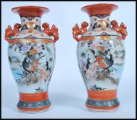 A pair of Japanese Kutani vases, Meiji, with twin handles modelled as dogs of fo, the panels
