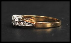 A hallmarked 9ct gold and diamond three stone ring having illusion set diamonds and diamond set