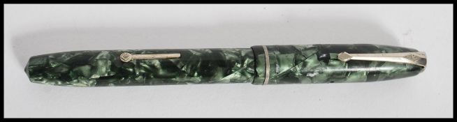 A 14ct gold nib Conway Stewart fountain pen having a lever fill action with a crackled green body.