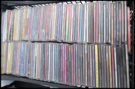 A large collection of CD singles and CD albums featuring various artists and genres to include