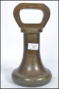 A large antique Avery Ltd bronze 10 kilogram weight of bell / pawn form. The weight stamped Avery No