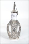 A Chinese silver perfume scent bottle having three oval glass panels. Marks to base.