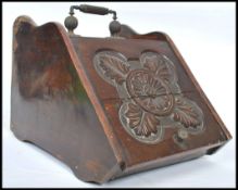 A 19th century Victorian oak coal scuttle purdonium having a central carved medallion with