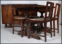 A 1940's oak draw leaf refectory extending dining table together with a set of 4 matching dining