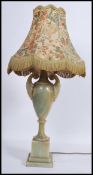 A vintage 20th century onyx table lamp of urn form. Raised on a stepped square base with scrolled