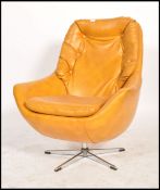 A retro 1960's - mid century vivid orange faux leather swivel armchair of angular form being
