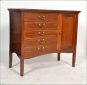 An Edwardian mahogany music cabinet being raised on square tapered legs with a bank of 5 fall