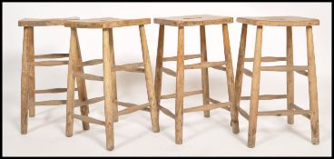 A set of 4 retro 20th century Industrial lab - laboratory stools raised on turned legs with