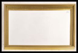 A 20th century contemporary wall mirror of rectangular form having a decorative gilt frame with a