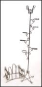 A 1970's retro magazine rack of wrought metal construction together with a similar ebonised