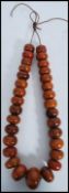 A large unusual Chinese prayer bead necklace. Each oversized bead of roundel form being strung on
