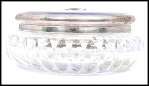 A silver hallmarked and enamel top large dressing cut glass dressing table jar pot. The beautiful