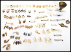 A large collection of vintage 20th century cuff links, buttons , tie clips etc. Many pairs and