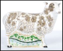 A Royal Crown Derby paperweight of a Jacob Sheep, with gold stopper, red stamp to base and dating to