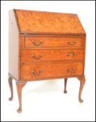 A mid century Queen Anne revival walnut bureau desk raised on cabriole legs with a series of drawers