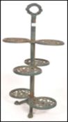 A vintage 20th century cast iron garden planter stand having six circular branches with a pierced