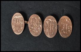 A pair of hallmarked 9ct gold cufflinks cuff links of oval lozenge form being monogrammed. Weighs