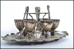 A silver plated six person egg codler breakfast set having a scalloped stand tray.